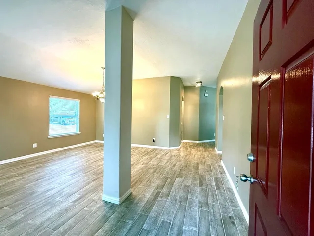 a view of hallway with wooden floor