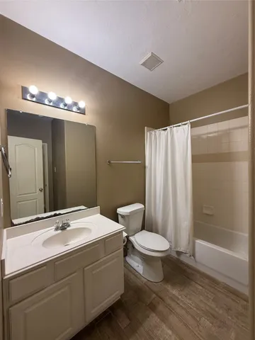a bathroom with a double vanity sink toilet and shower