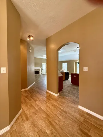 a view of a big room with wooden floor and a bathroom