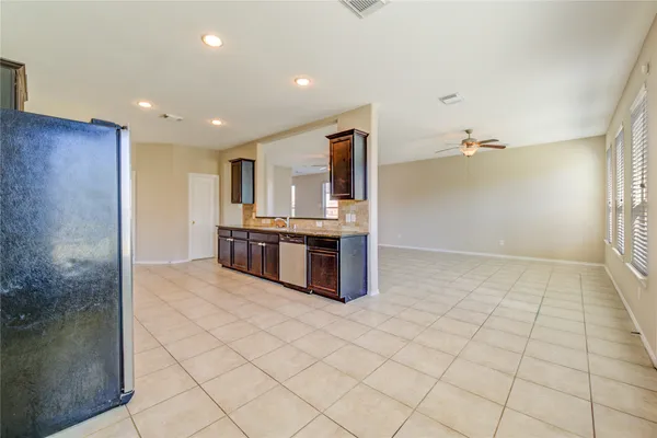 a kitchen with stainless steel appliances a sink and cabinets