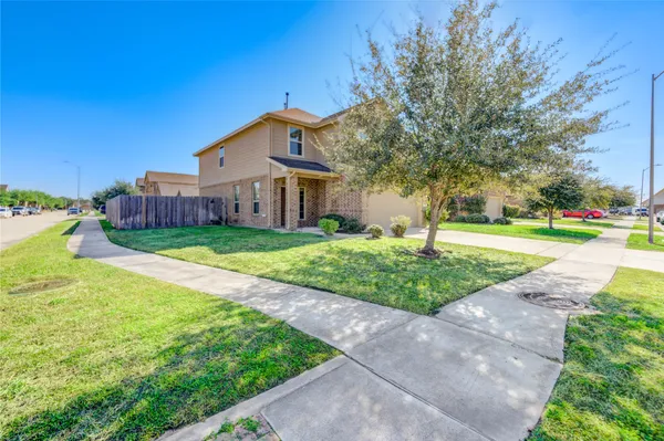 a front view of a house with yard and green space