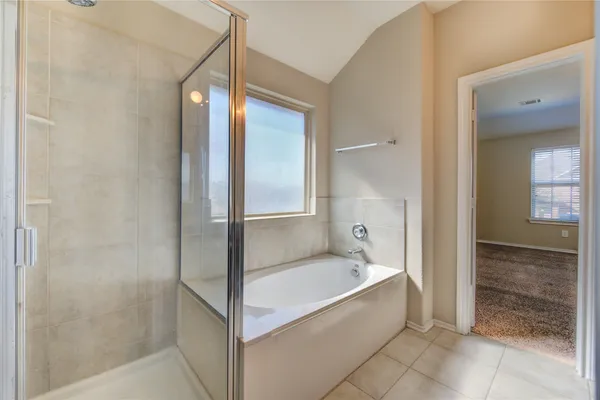 a spacious bathroom with a bathtub and a shower