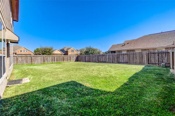 a view of a house with backyard and porch