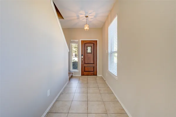 a view of a hallway with a chandelier