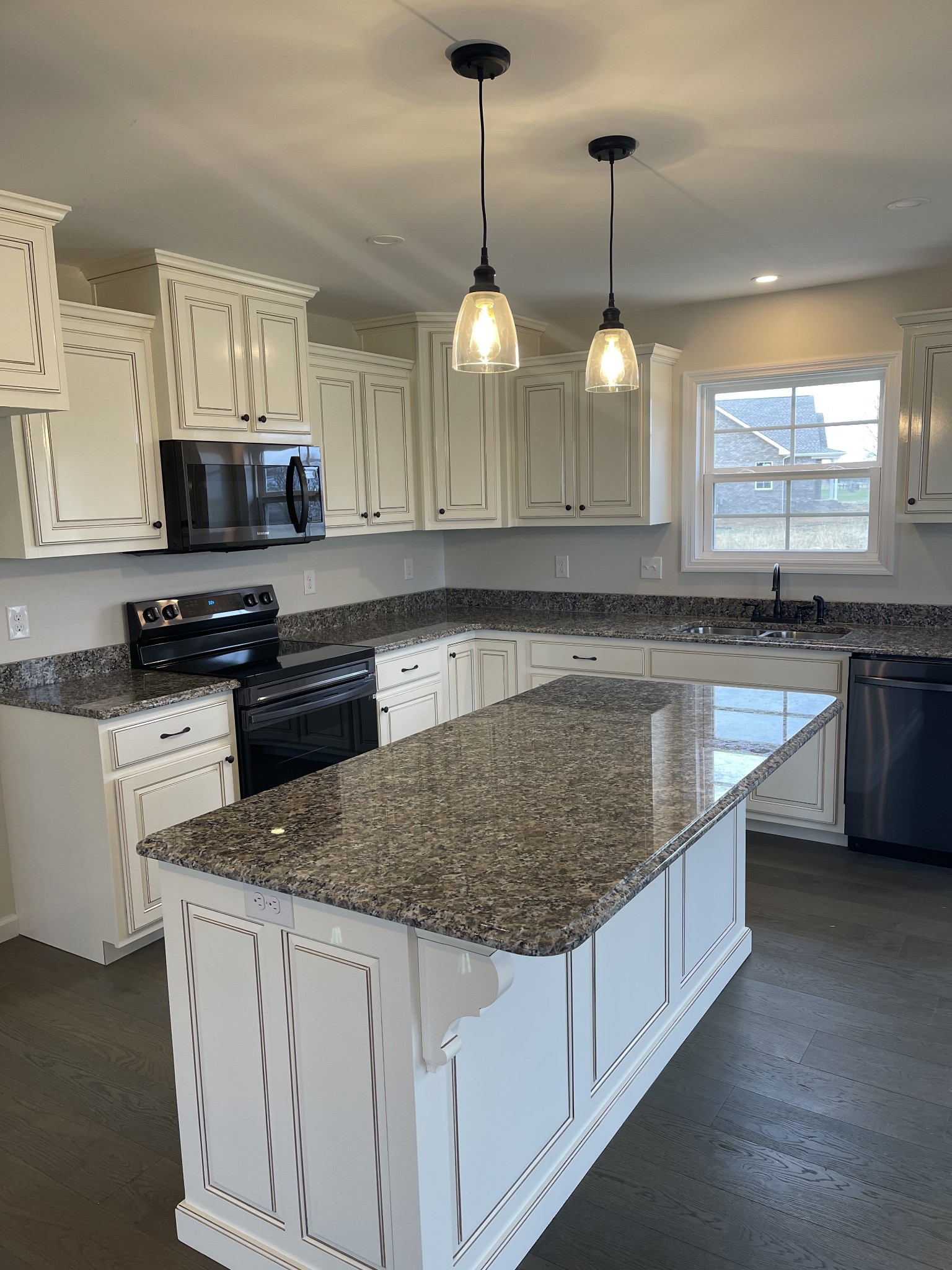 2569 Coleytown Road Lafayette, TN 37083 - Photo 18 of 20 a kitchen with stainless steel appliances granite countertop a sink a stove a refrigerator a center island a counter space and a window