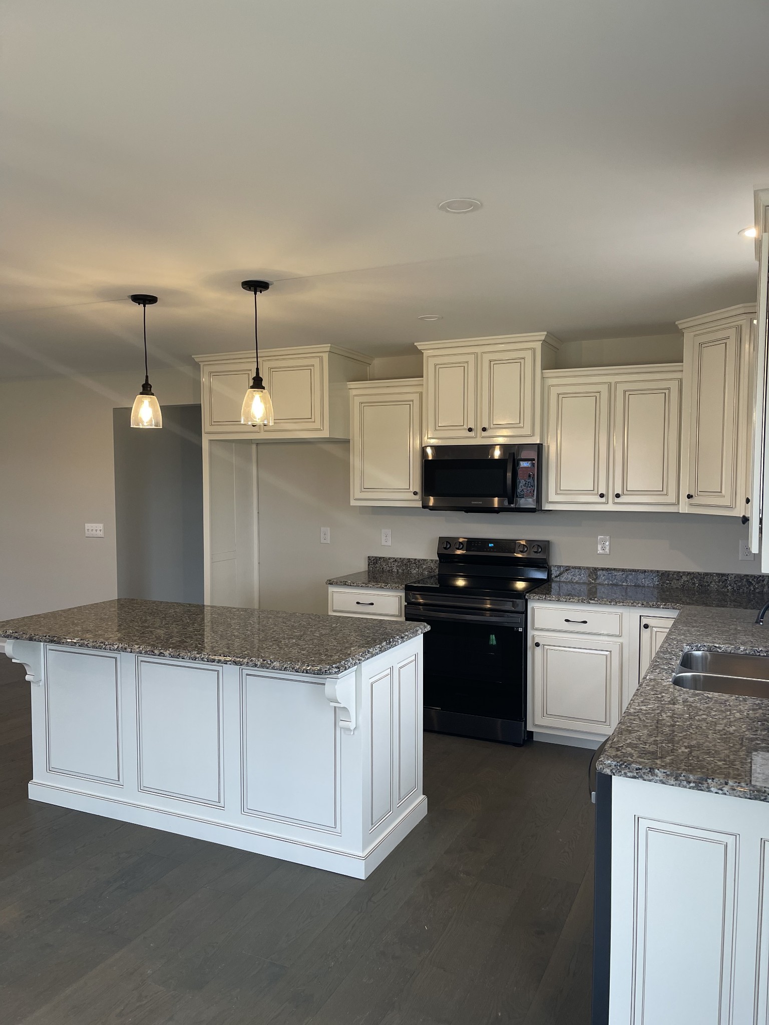 2569 Coleytown Road Lafayette, TN 37083 - Photo 4 of 20 a kitchen with granite countertop a sink and a stove top oven