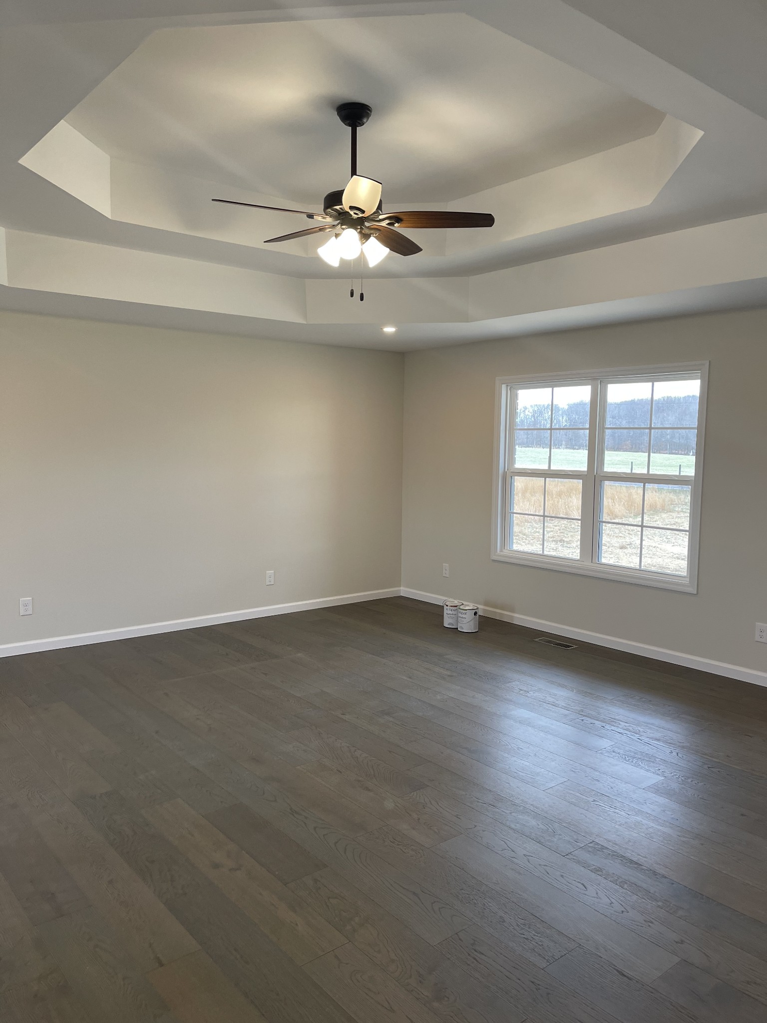2569 Coleytown Road Lafayette, TN 37083 - Photo 8 of 20 an empty room with wooden floor fan and windows