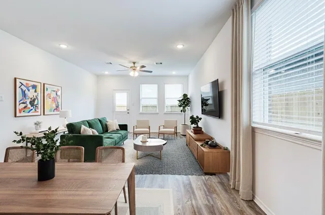 a living room with furniture and a potted plant