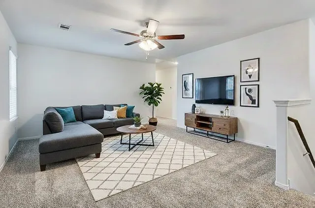 a living room with furniture and a flat screen tv