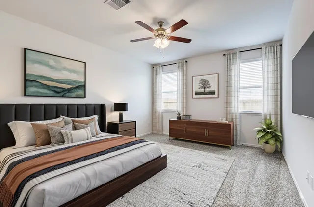 a bedroom with a large bed and a couch