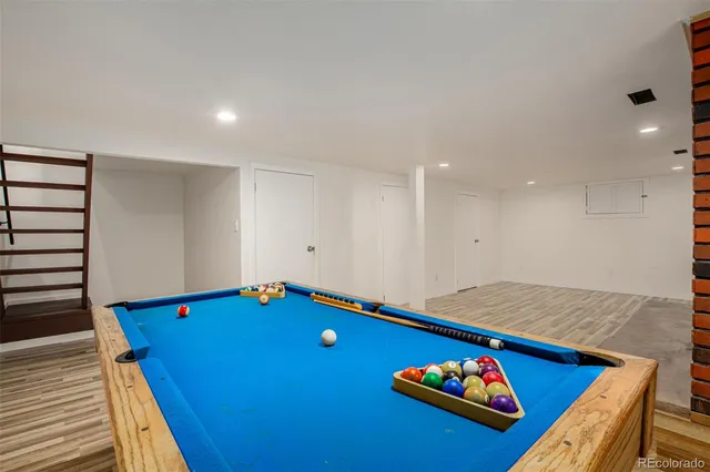 a room with pool table and gym equipment