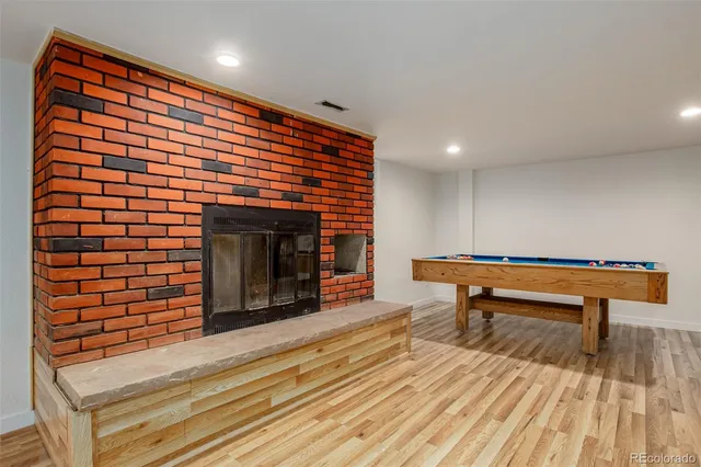 a hallway with a bench and a fireplace