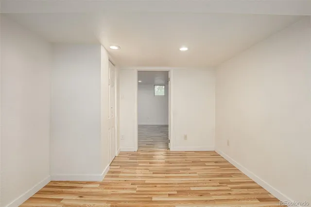 a view of a room with wooden floor