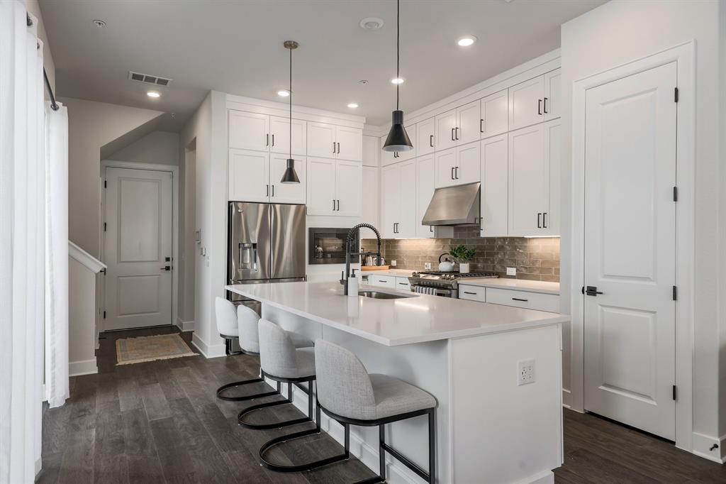 3907 Tilley Street Austin, TX 78723 - Photo 5 of 26 a kitchen with kitchen island a stove a table and chairs in it