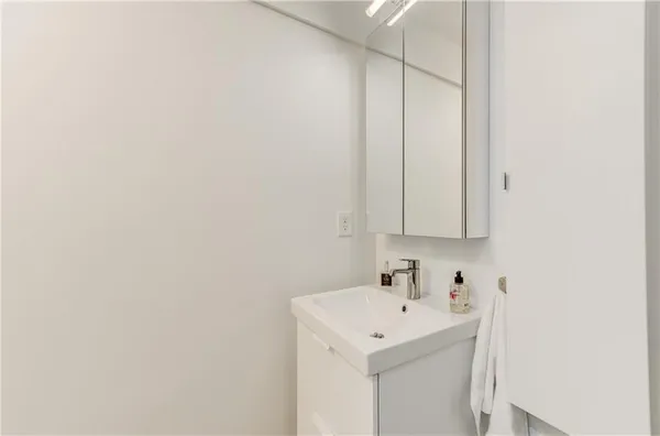 a bathroom with a sink a vanity and a vanity