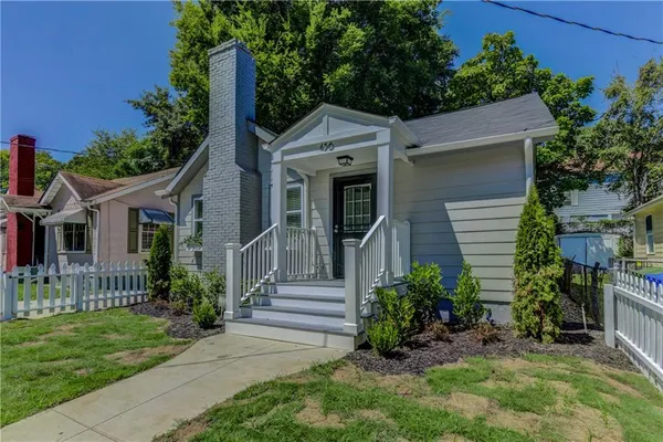 a front view of a house with a garden