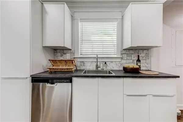a kitchen with stainless steel appliances granite countertop a sink stove and cabinets