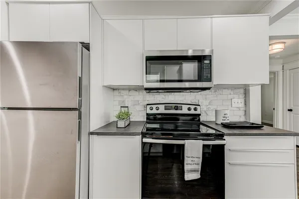 a kitchen with a refrigerator stove and microwave