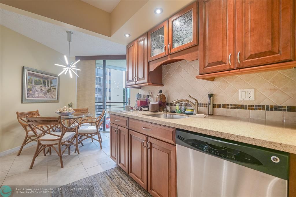 7300 Radice Court, Unit 302 Lauderhill, FL 33319 - Photo 14 of 81 a kitchen with stainless steel appliances granite countertop a sink and cabinets