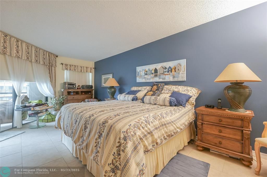 7300 Radice Court, Unit 302 Lauderhill, FL 33319 - Photo 22 of 81 a bedroom with a bed and wooden floor