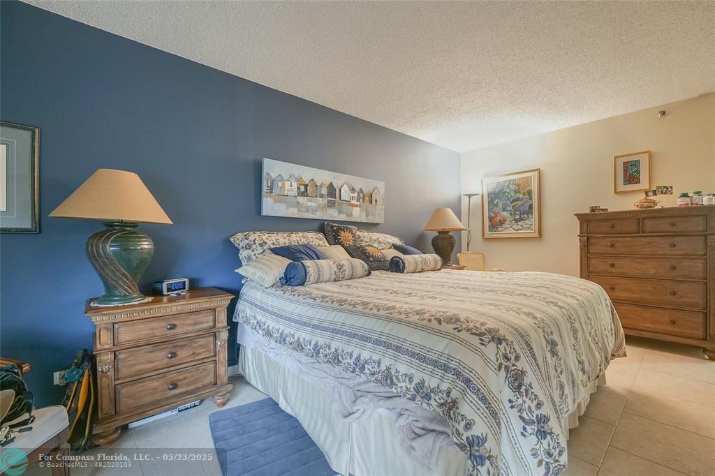 7300 Radice Court, Unit 302 Lauderhill, FL 33319 - Photo 24 of 81 a bedroom with a bed and a dresser