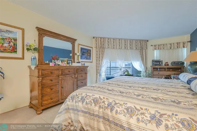 a bedroom with a bed and a dresser in it