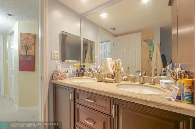 a bathroom with a granite countertop sink and a toilet