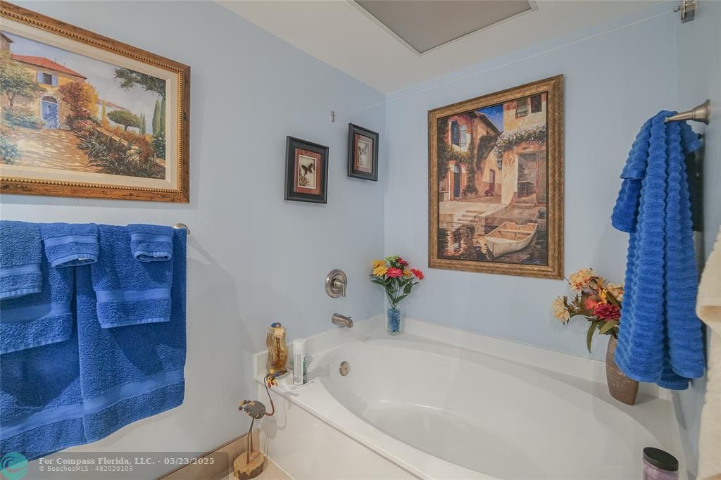 7300 Radice Court, Unit 302 Lauderhill, FL 33319 - Photo 30 of 81 a white bath tub sitting next to a white toilet
