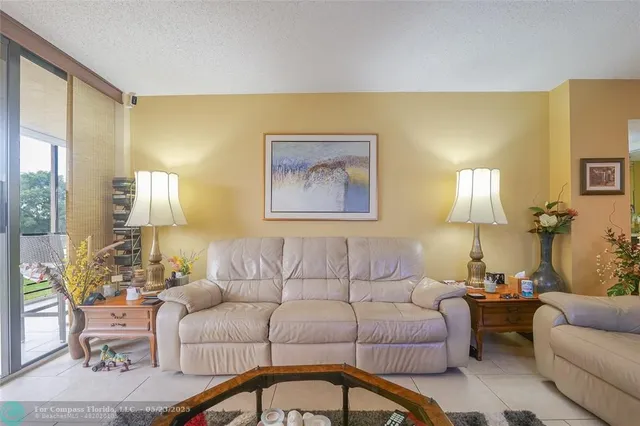 a living room with couches and painting on the wall