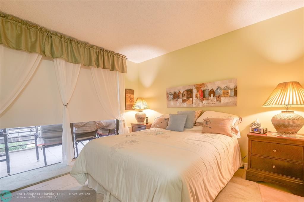 7300 Radice Court, Unit 302 Lauderhill, FL 33319 - Photo 33 of 81 a bedroom with double bed and a cabinets