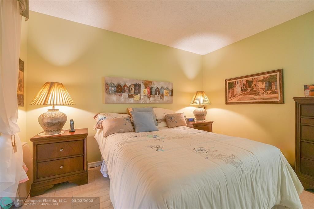 7300 Radice Court, Unit 302 Lauderhill, FL 33319 - Photo 34 of 81 a bedroom with a bed and wooden floor