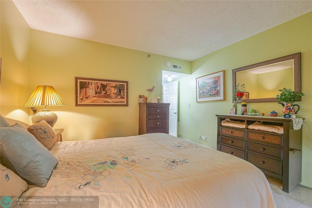 7300 Radice Court, Unit 302 Lauderhill, FL 33319 - Photo 35 of 81 a bedroom with a bed and furniture