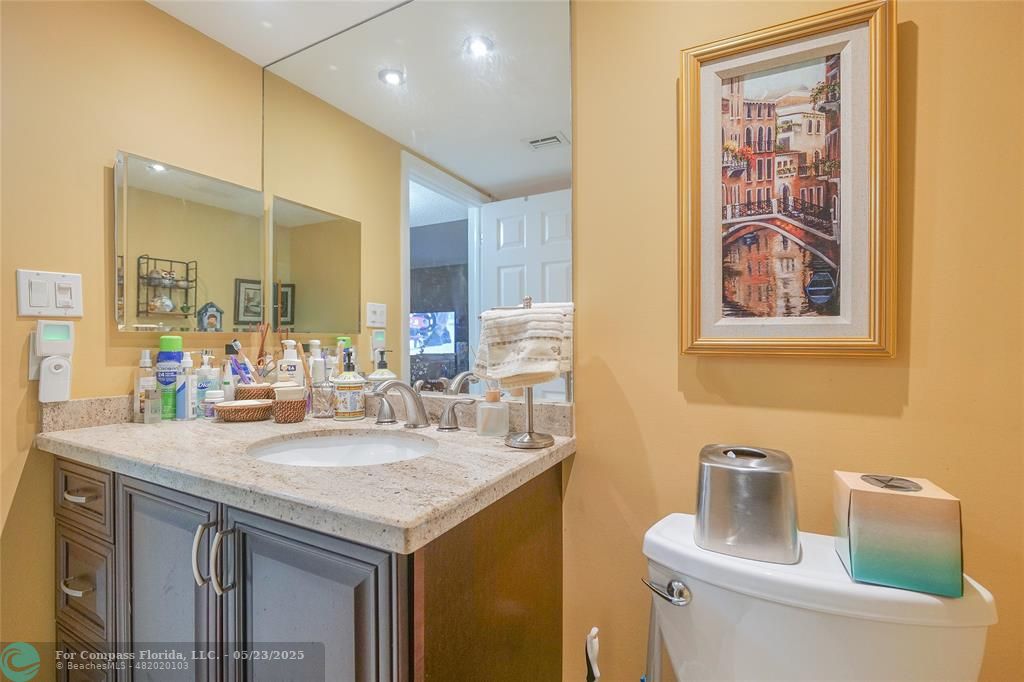7300 Radice Court, Unit 302 Lauderhill, FL 33319 - Photo 38 of 81 a bathroom with a granite countertop sink and a toilet