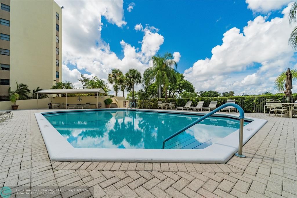 7300 Radice Court, Unit 302 Lauderhill, FL 33319 - Photo 51 of 81 a view of swimming pool with a lounge chairs