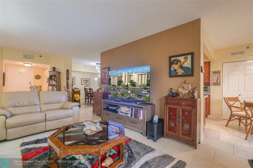 7300 Radice Court, Unit 302 Lauderhill, FL 33319 - Photo 6 of 81 a living room with furniture and a flat screen tv