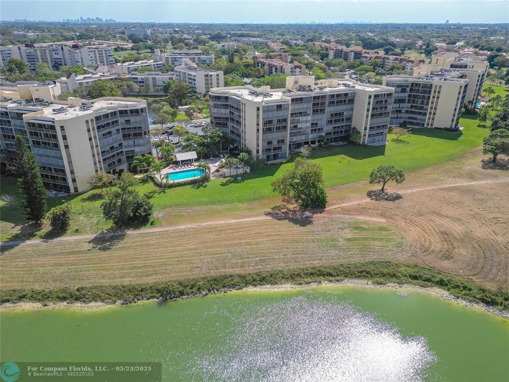 7300 Radice Court, Unit 302 Lauderhill, FL 33319 - Photo 69 of 81 an aerial view of a house with a yard and lake view