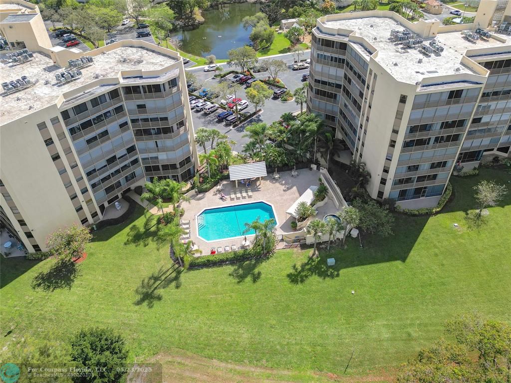 7300 Radice Court, Unit 302 Lauderhill, FL 33319 - Photo 70 of 81 a aerial view of a residential apartment building with a yard