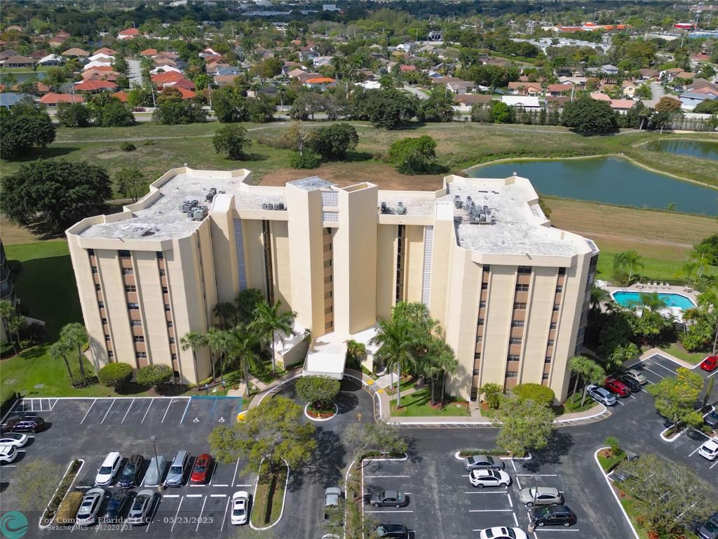 7300 Radice Court, Unit 302 Lauderhill, FL 33319 - Photo 73 of 81 an aerial view of a house with a garden and lake view