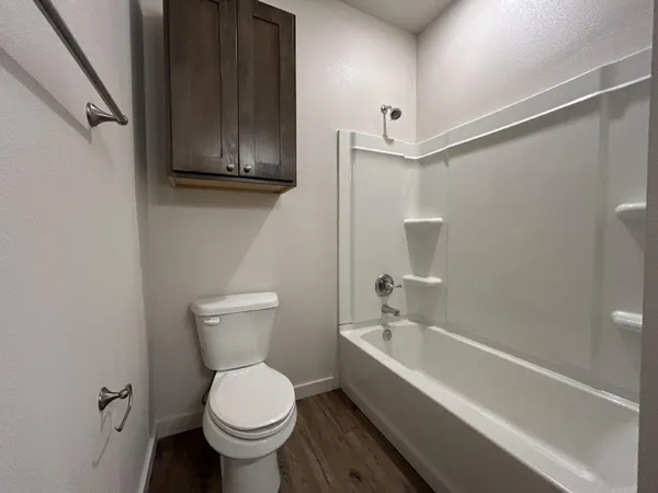 a bathroom with a toilet a sink and bathtub