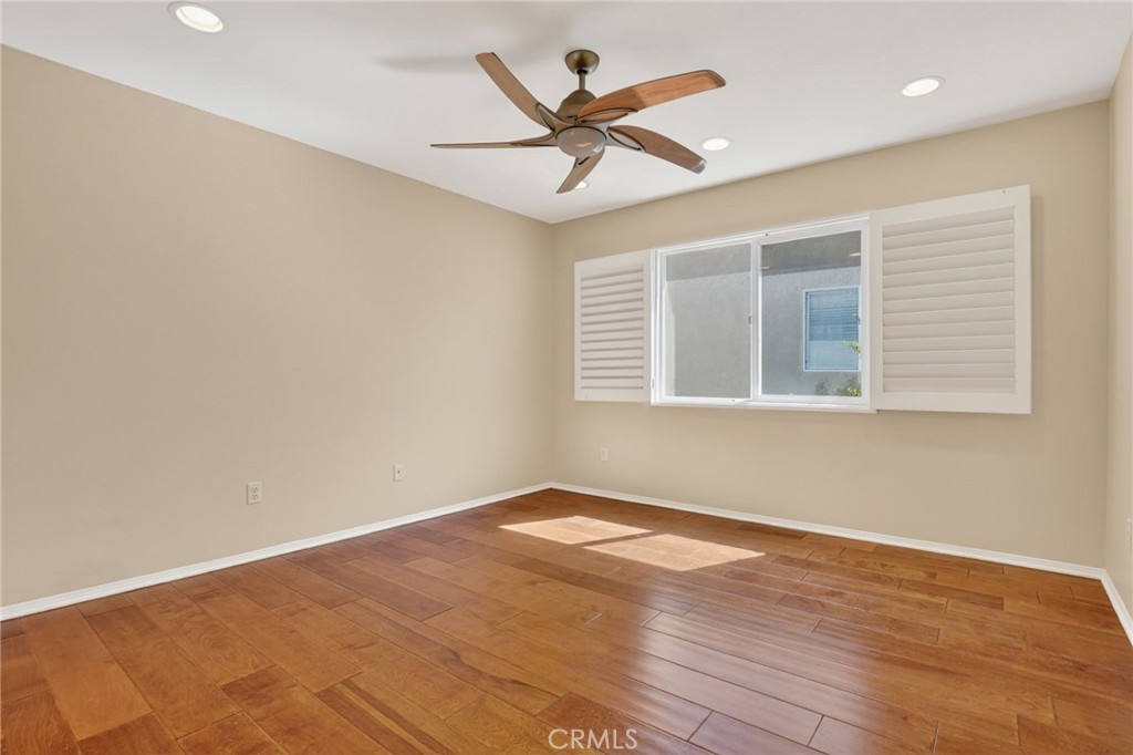 20543 Pesaro Porter Ranch Porter Ranch, CA 91326 - Photo 51 of 67 an empty room with wooden floor and ceiling fan