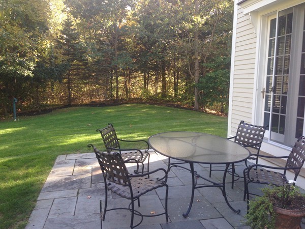 4 Lowerfield Road Weston, MA 02493 - Photo 20 of 20 a view of a backyard with table and chairs and a slide