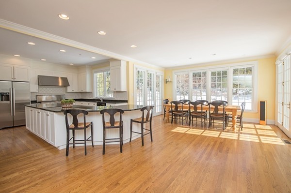 4 Lowerfield Road Weston, MA 02493 - Photo 3 of 20 a open kitchen with granite countertop a stove a sink a dining table and chairs
