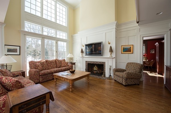 4 Lowerfield Road Weston, MA 02493 - Photo 4 of 20 a living room with furniture flat screen tv and a fireplace
