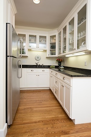 4 Lowerfield Road Weston, MA 02493 - Photo 9 of 20 a large kitchen with granite countertop a stove top oven a sink a refrigerator and white cabinets