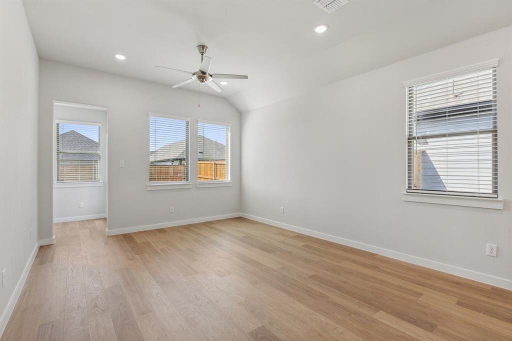 2717 Parkside Trail Princeton, TX 75407 - Photo 8 of 21 an empty room with windows and ceiling fan