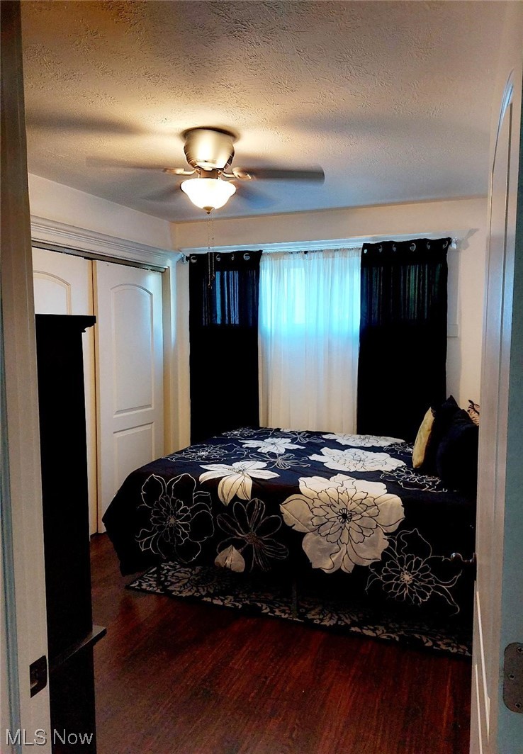 3061 Sandy Lake Road Ravenna, OH 44266 - Photo 9 of 15 Hardwood floored bedroom with a textured ceiling and ceiling fan