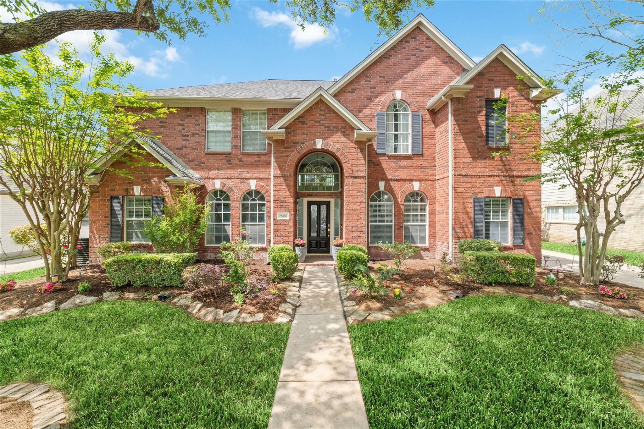 22406 Piper Terrace Lane Katy, TX 77450 - Photo 2 of 44 a front view of a house with garden