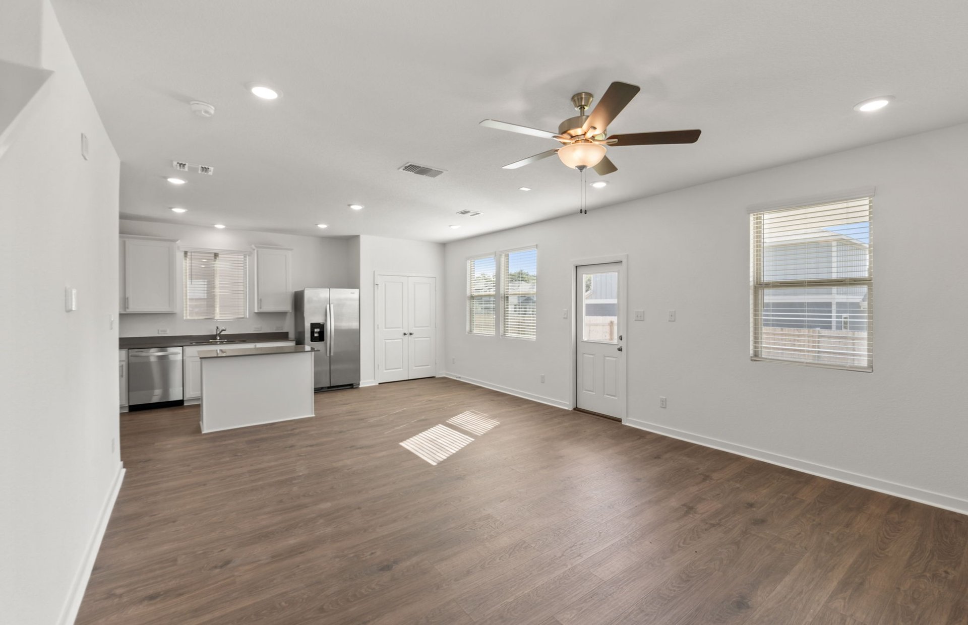 590 Rubber Tree Way Buda, TX 78610 - Photo 6 of 22 a view of an empty room with kitchen appliances and a window