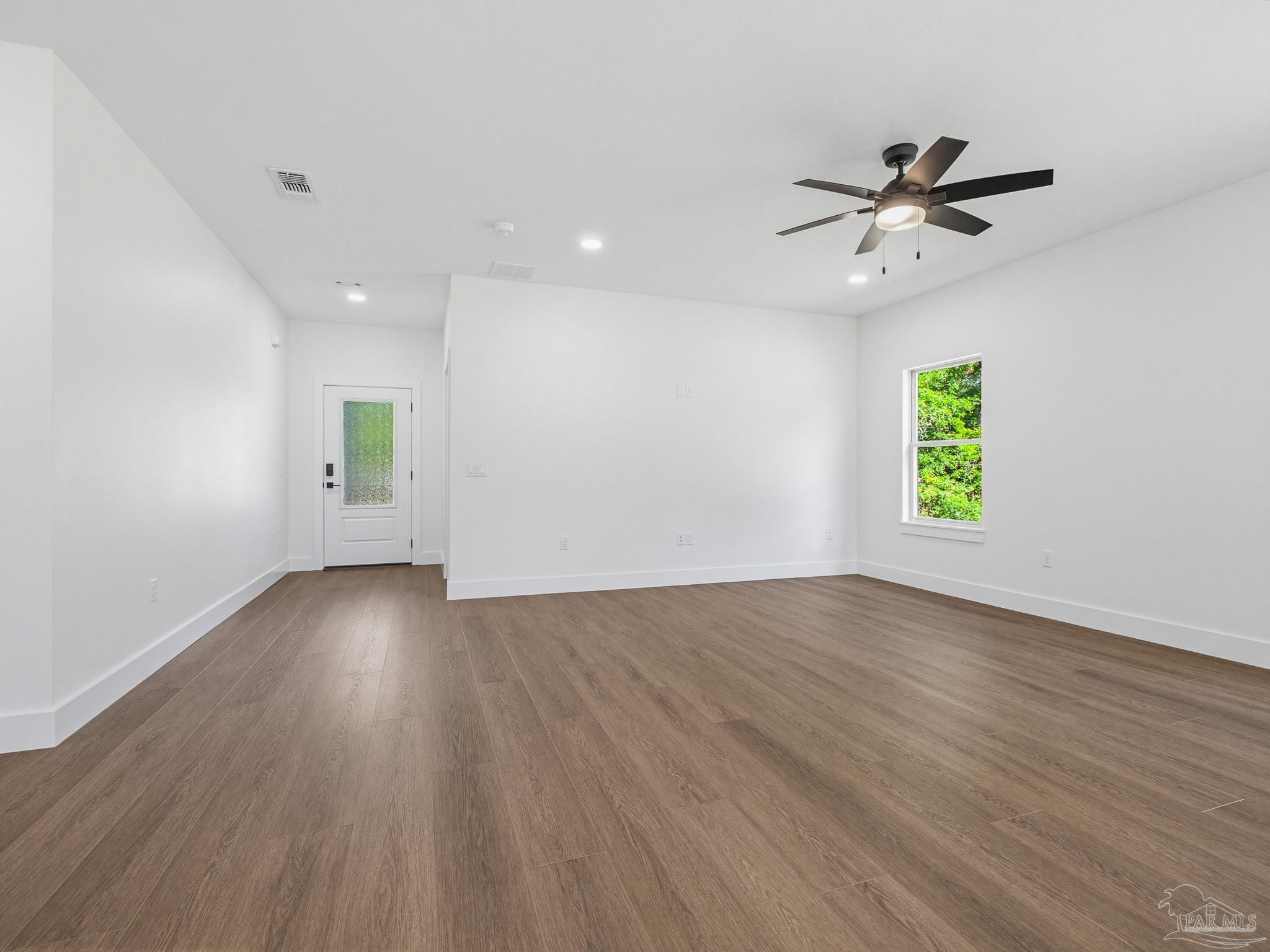 5724 Riviera Drive Milton, FL 32583 - Photo 11 of 52 wooden floor in an empty room with a window