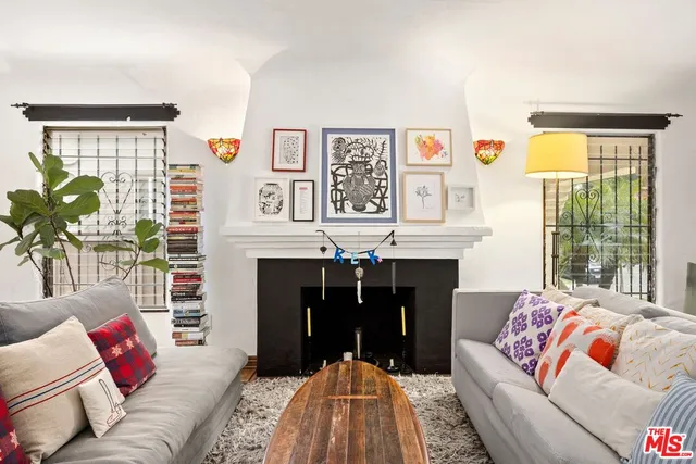 a living room with furniture fireplace and window